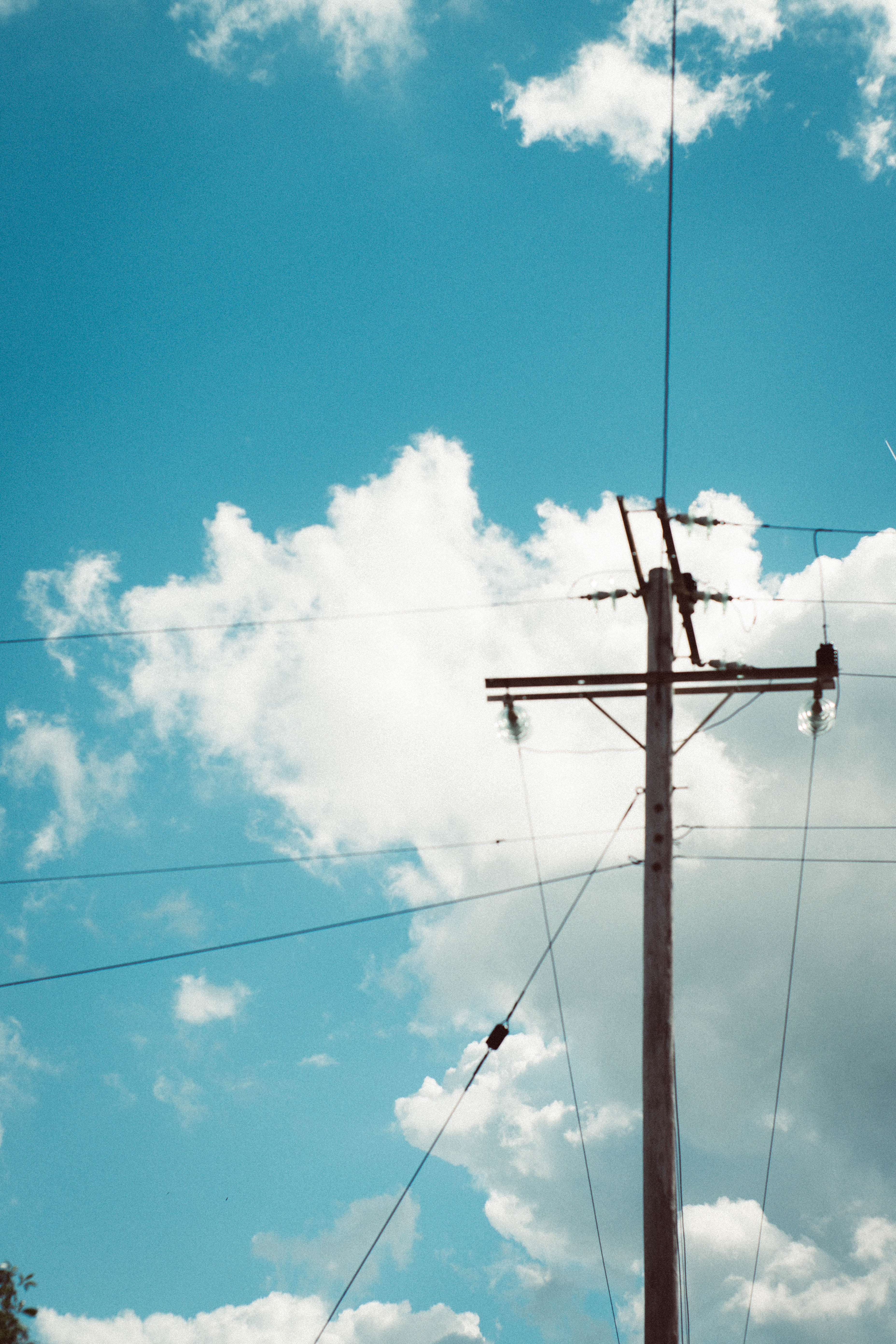 electric pole in front of blue sky